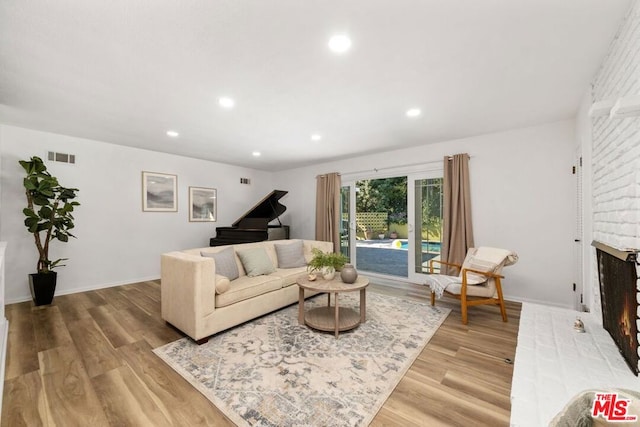 living room featuring a fireplace and light hardwood / wood-style floors