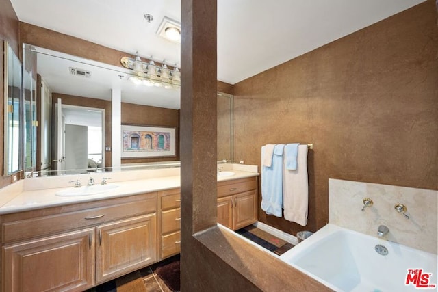 bathroom featuring tile patterned floors, vanity, a bath, and lofted ceiling