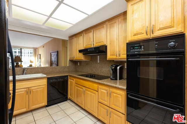 kitchen with decorative backsplash, light tile patterned floors, sink, and black appliances