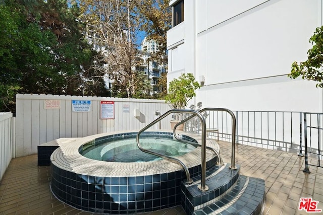 view of swimming pool featuring a community hot tub