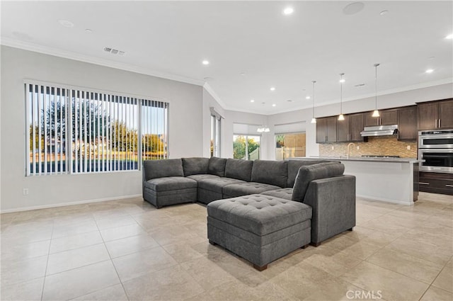 living room with light tile patterned floors and crown molding