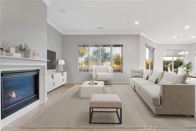 living room featuring an inviting chandelier and ornamental molding