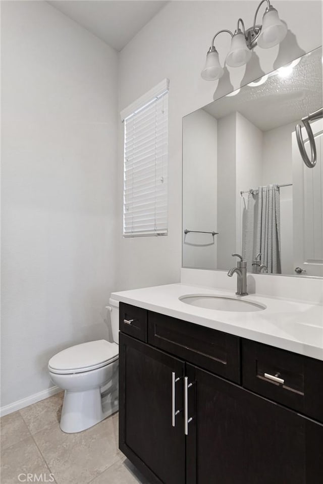 bathroom with vanity, an inviting chandelier, tile patterned flooring, toilet, and curtained shower