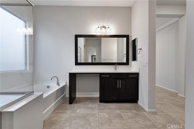 bathroom with vanity and a tub to relax in