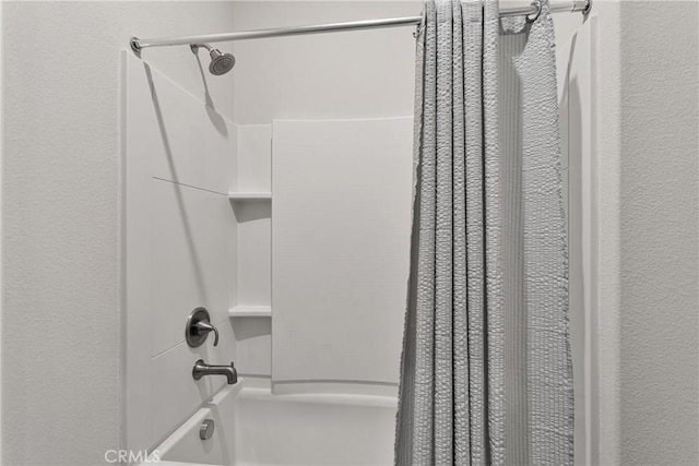 bathroom with shower / bathtub combination with curtain