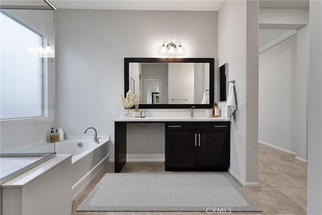 bathroom featuring tile patterned flooring, vanity, and a bath