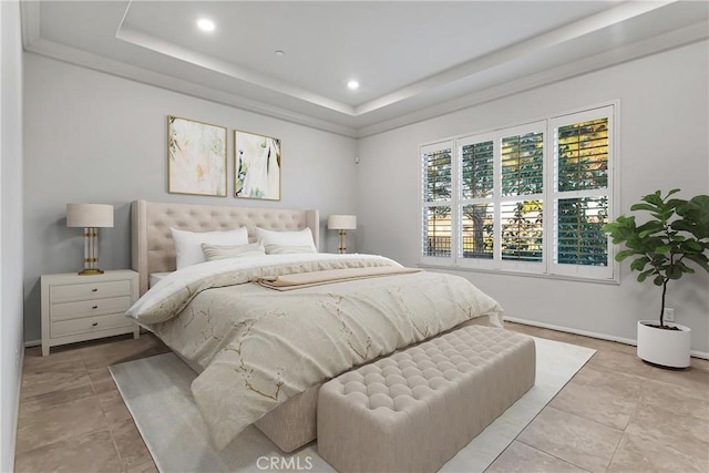 bedroom with light tile patterned floors and a tray ceiling