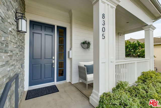 doorway to property featuring covered porch