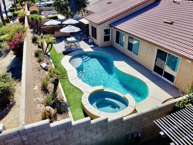 view of swimming pool with a patio area and an in ground hot tub