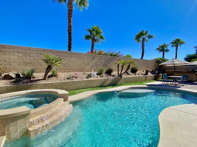 view of pool featuring an in ground hot tub and a patio