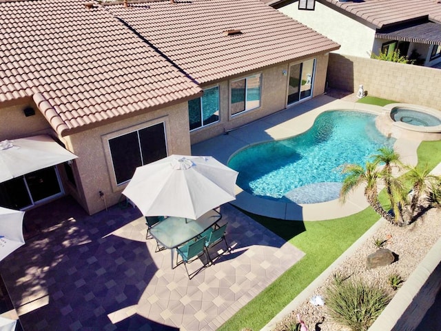 view of pool featuring an in ground hot tub and a patio