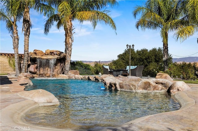 view of pool featuring a mountain view and pool water feature