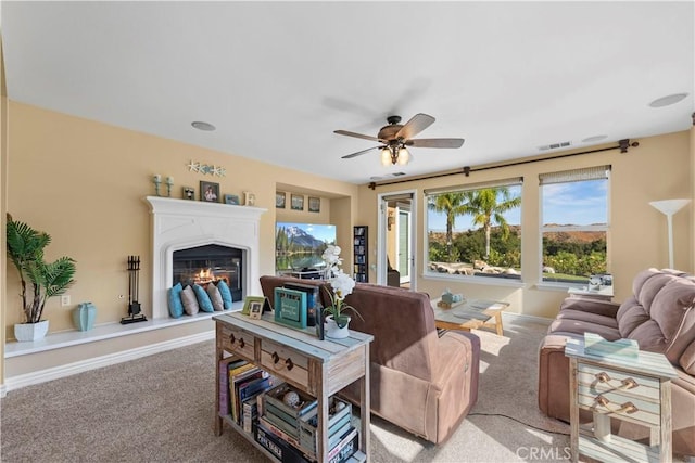 living room with ceiling fan and light colored carpet