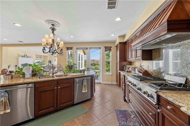 kitchen featuring custom exhaust hood, an inviting chandelier, sink, decorative light fixtures, and stainless steel appliances