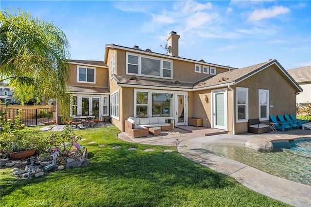 rear view of house featuring an outdoor living space, a patio, and a lawn