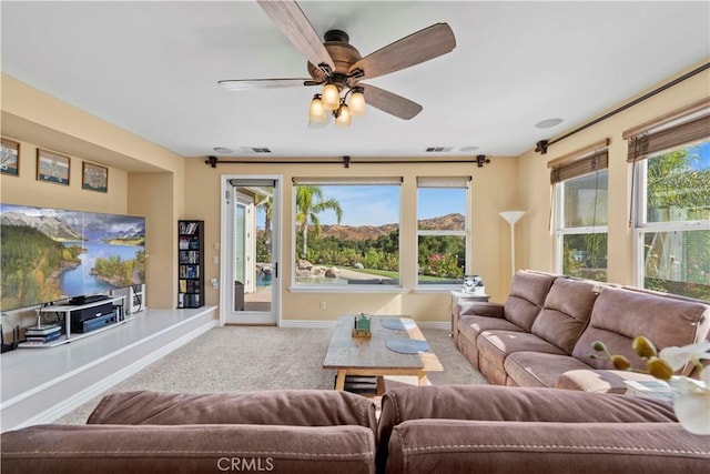 living room featuring carpet flooring and ceiling fan