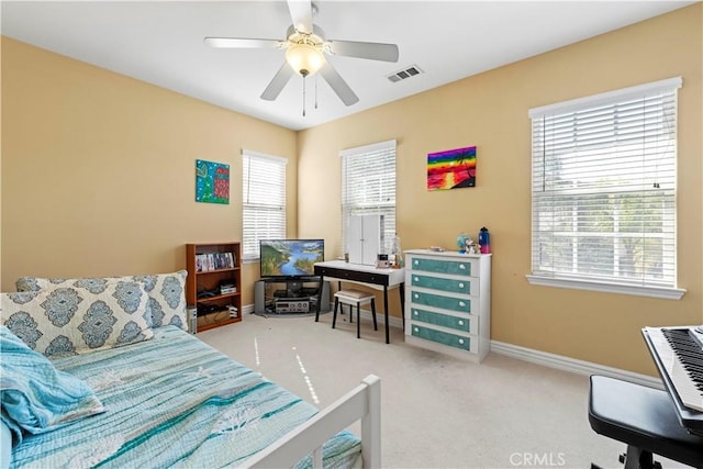 bedroom with ceiling fan and light carpet