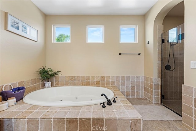 bathroom featuring separate shower and tub