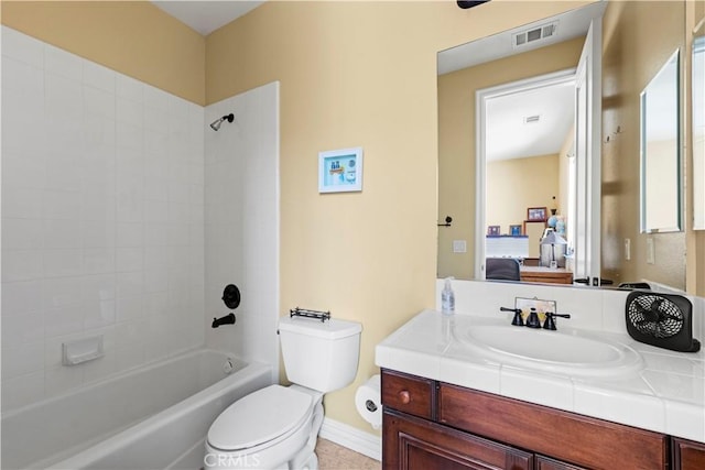 full bathroom featuring toilet, vanity, and tiled shower / bath combo