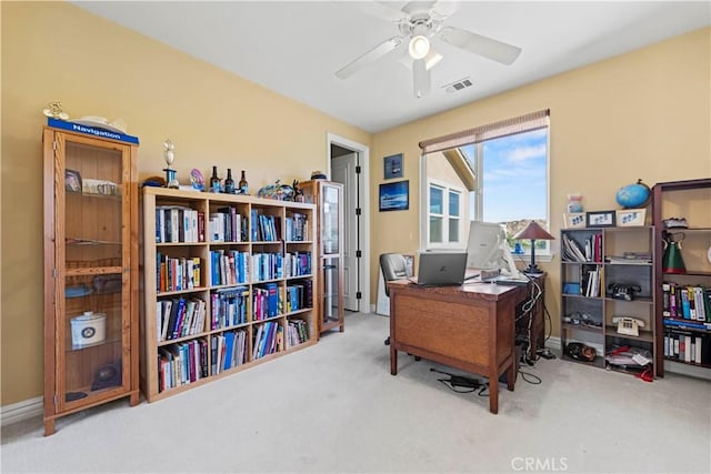 carpeted office featuring ceiling fan