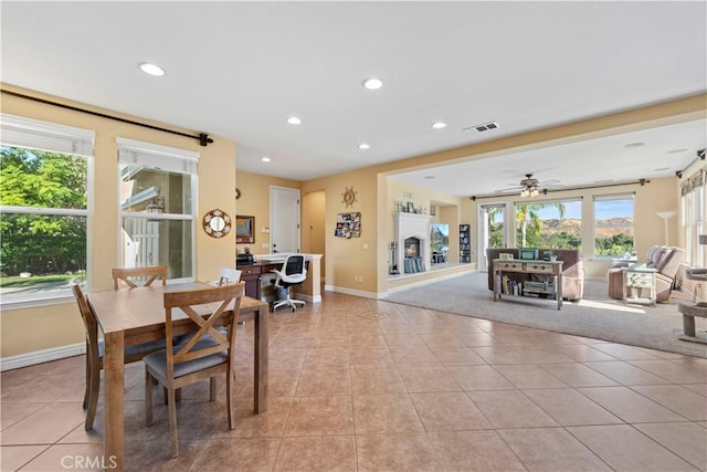 dining area with ceiling fan, light tile patterned floors, and a healthy amount of sunlight