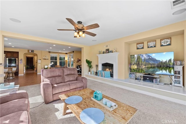 living room with carpet flooring and ceiling fan