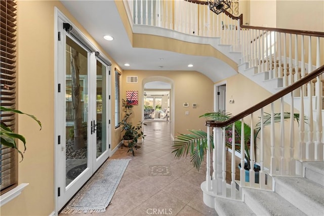 foyer with light tile patterned floors and french doors