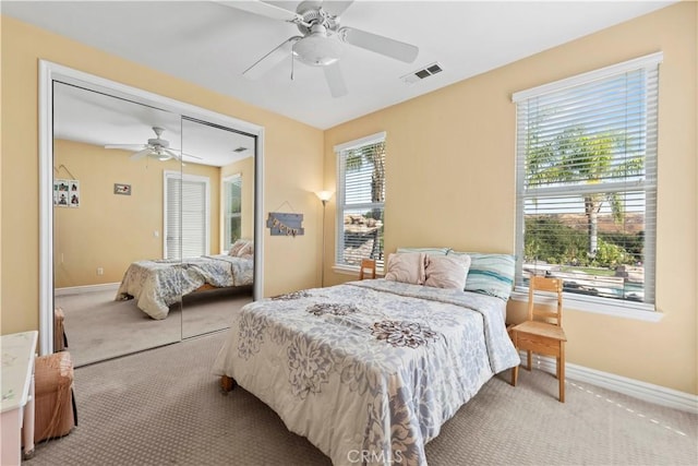 bedroom featuring carpet flooring, ceiling fan, and a closet