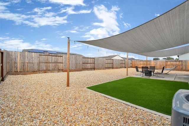 view of yard featuring central air condition unit and a patio area