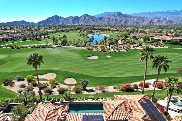 surrounding community with a water and mountain view