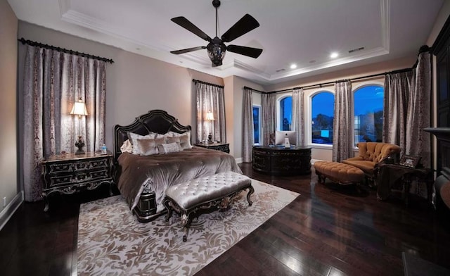 bedroom with ornamental molding, a raised ceiling, ceiling fan, and dark wood-type flooring