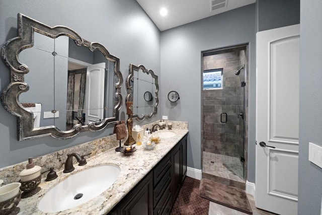 bathroom with tile patterned floors, a shower with door, and vanity