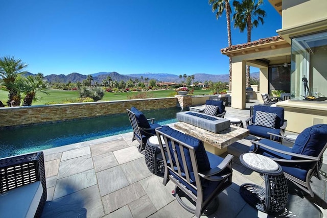 view of patio / terrace featuring a mountain view and an outdoor fire pit