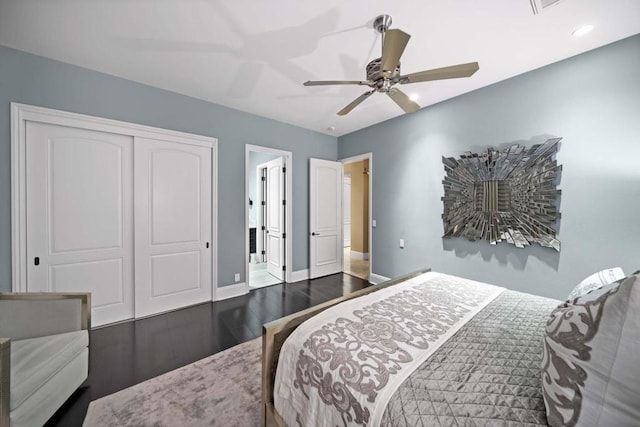 bedroom with a closet, ceiling fan, and dark hardwood / wood-style flooring