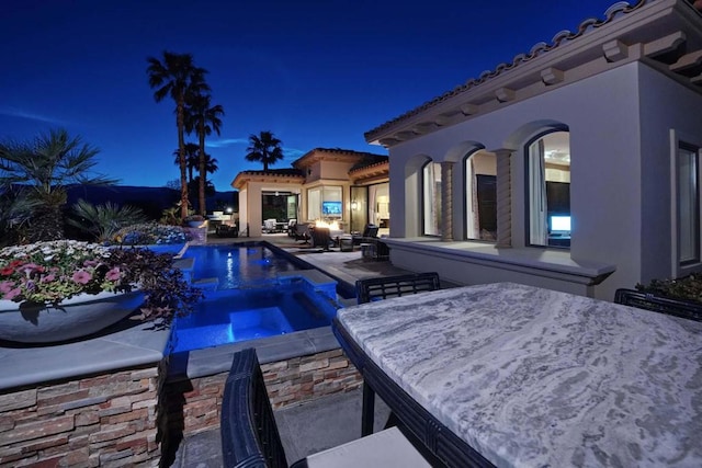 view of pool featuring a patio area and an in ground hot tub