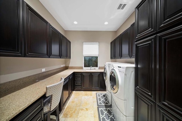 laundry area with cabinets, sink, and washing machine and clothes dryer