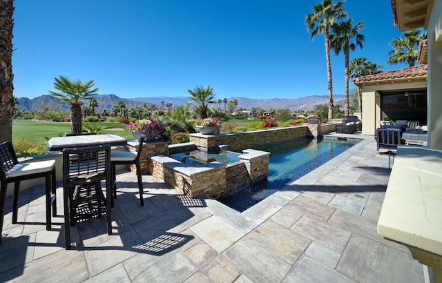 view of pool featuring a mountain view and a patio