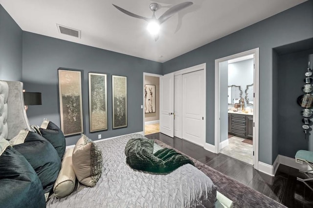 bedroom featuring ceiling fan, dark wood-type flooring, and ensuite bath