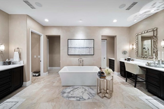 bathroom with vanity and a tub