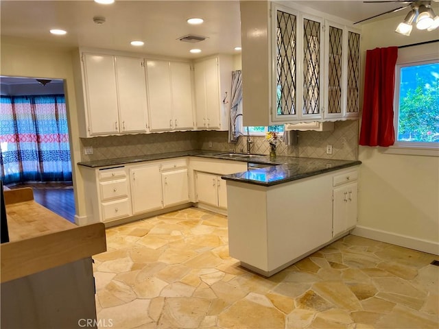 kitchen featuring white cabinetry, sink, ceiling fan, tasteful backsplash, and kitchen peninsula