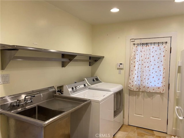 clothes washing area featuring separate washer and dryer and sink