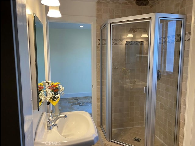 bathroom with walk in shower and sink