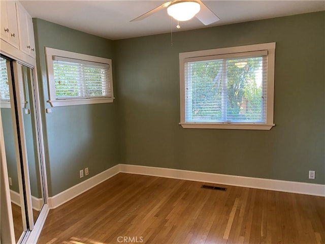 unfurnished room with ceiling fan and wood-type flooring