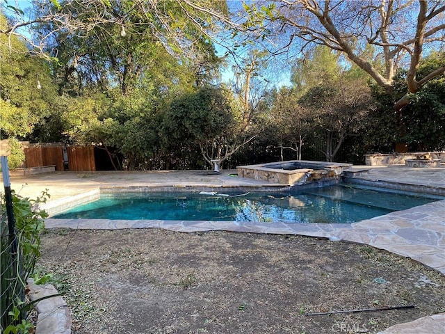 view of pool with an in ground hot tub and a patio