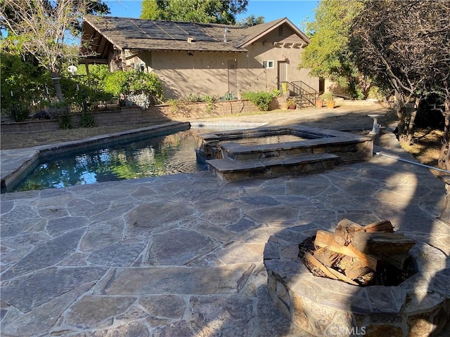 view of pool featuring an in ground hot tub and a patio area