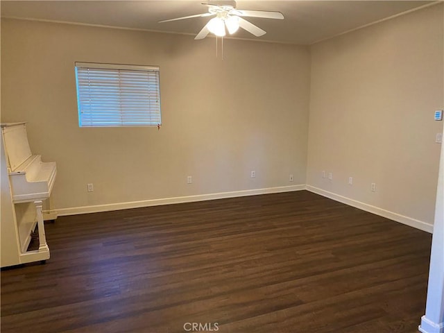 spare room with ceiling fan and dark hardwood / wood-style floors