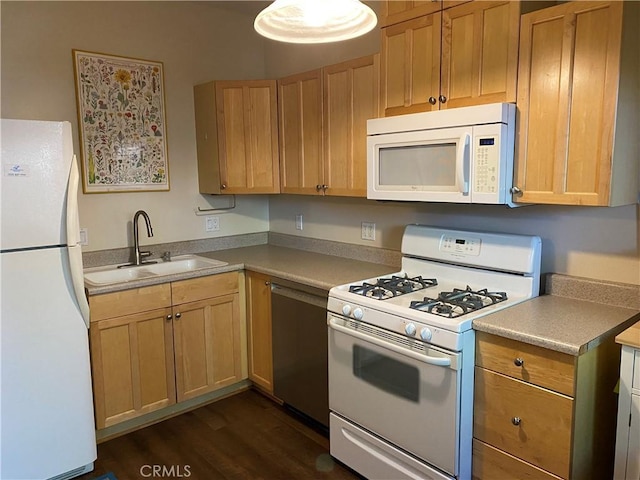 kitchen featuring light brown cabinets, white appliances, sink, and dark wood-type flooring