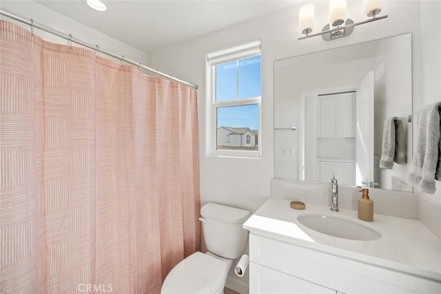 bathroom featuring vanity and toilet