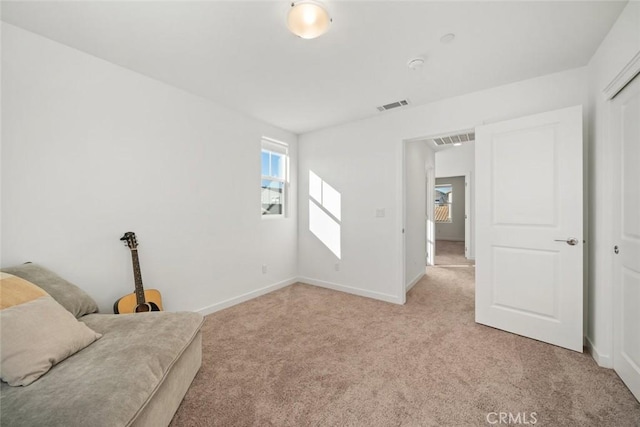 unfurnished room featuring light carpet