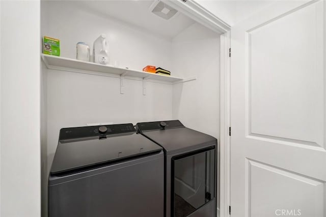 clothes washing area featuring independent washer and dryer